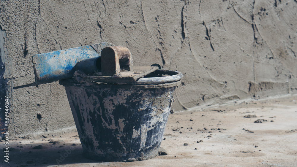 Powder Cement and sand mixing bucket tank, trowel, and plastering equipment in construction site. Powder Cement and sand mixing bucket tank, trowel, and plastering equipment in construction site.