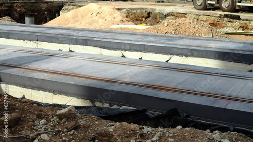 A view of tram rails construction works and building materials on a city road. 