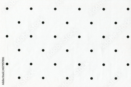 The texture of natural white cotton fabric with polka dots. Background of a simple natural thin fabric.