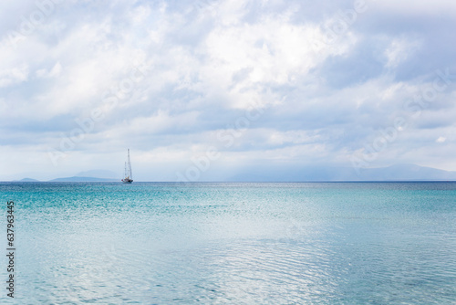 Tranquility scene landscape sailboat on the sea in a cloudy weather. Travel tourism relax satisfaction concept 