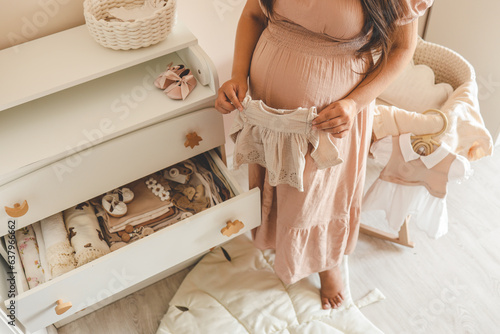 Photography Pregnant woman is getting ready for the maternity hospital, packing baby stuff