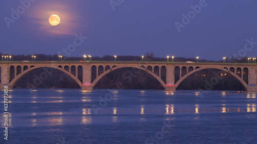Almost Full Moon Disappearing into the Clouds Behind Key Bridge at Dawn