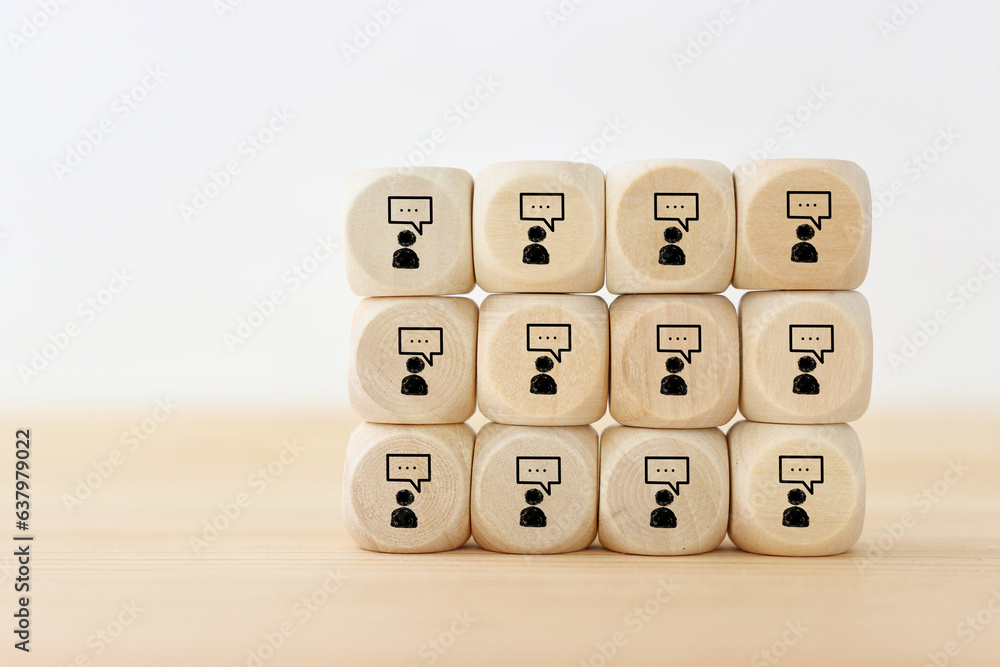 Wooden cubes with bubble speech signs. Concept of communication and dialog Wooden cubes with bubble speech signs. Concept of communication and dialog