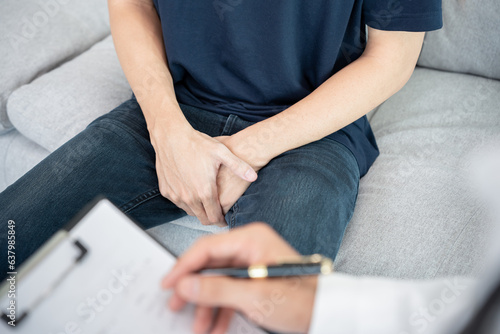 Canvas Print Man hold hand in front of private parts feeling discomfort and consult doctor