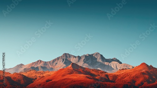 A majestic mountain range adorned in hues of red, orange, and gold, set against a clear blue sky - Generative ai