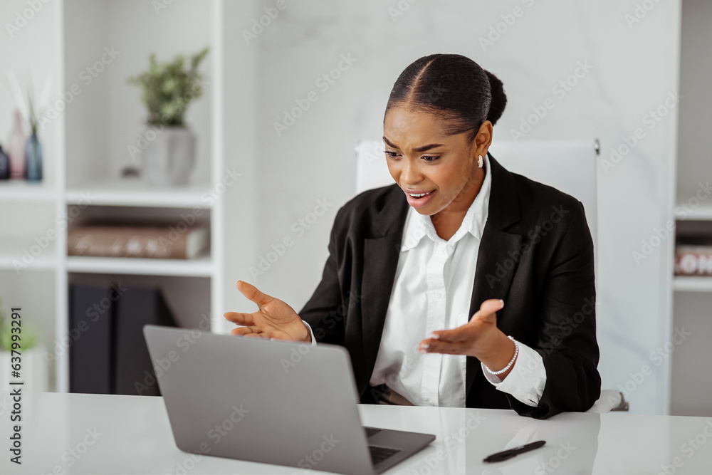 Working stress. Angry black businesswoman having problems with laptop computer, worried ceo sitting at desk in office Working stress. Angry black businesswoman having problems with laptop computer, worried ceo sitting at desk in office