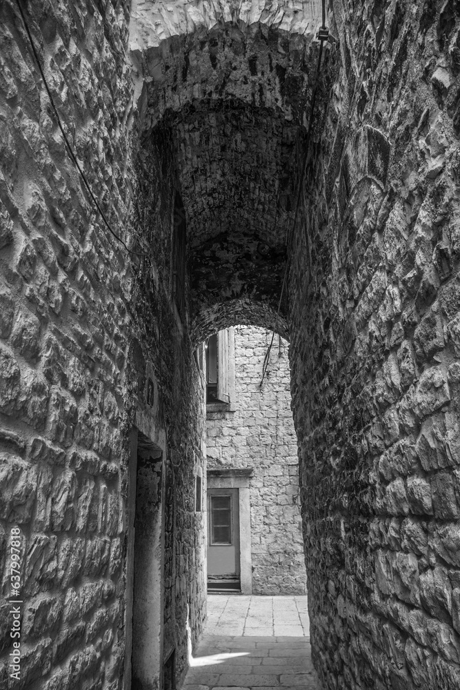 An arched alleyway in a quiet back street in the historic coastal city of Split in Croatia An arched alleyway in a quiet back street in the historic coastal city of Split in Croatia