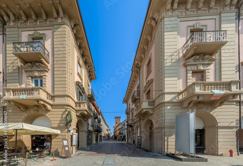 Alba, Langhe, Italy - August 20, 2023: Via Vittorio Emanuele the main pedestrian street between historic buildings, called via Maestra (Main street) , seen from piazza Ferrero... photo