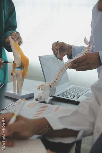Group of doctors reading a document in meeting room at hospital