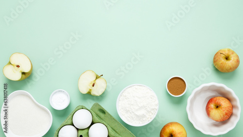 Ingredients for making classic cake pie with apples on green background. Concept homemade food, seasonal pastries. Top view, copy space