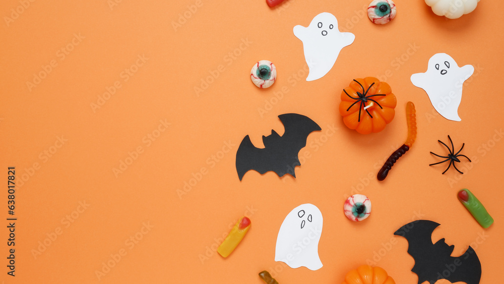 Halloween set decorations with pumpkins, ghost, spiders, bat on orange background. Happy halloween party. Flat lay, copy space, top view Halloween set decorations with pumpkins, ghost, spiders, bat on orange background. Happy halloween party. Flat lay, copy space, top view