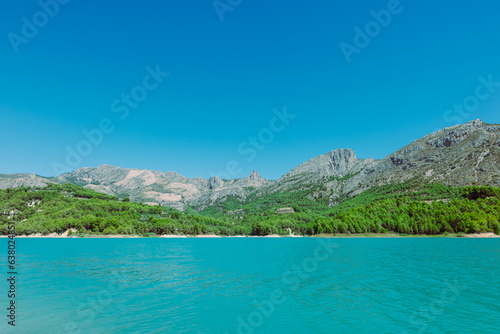 Mountain landscape, picturesque mountain lake on a summer morning, large panorama, Spain, Guadalest. High quality photo © PopOff