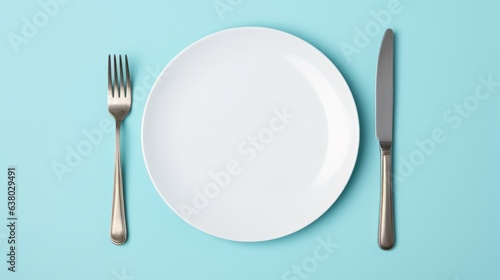 A white plate with a fork and knife on a blue background