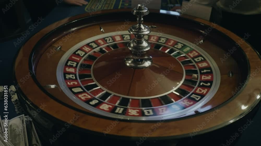 People play roulette in casino, game gold spinning roulette table close up, croupier dealer and roulette in a modern casino. People play roulette in casino, game gold spinning roulette table close up, croupier dealer and roulette in a modern casino.