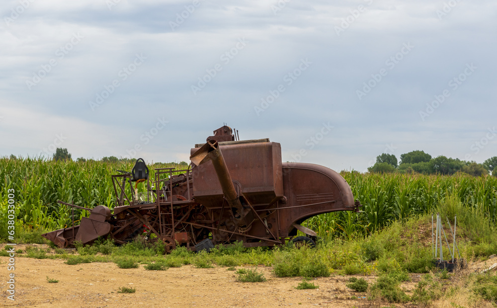 Old abandoned agricultural machinery rusting in the field