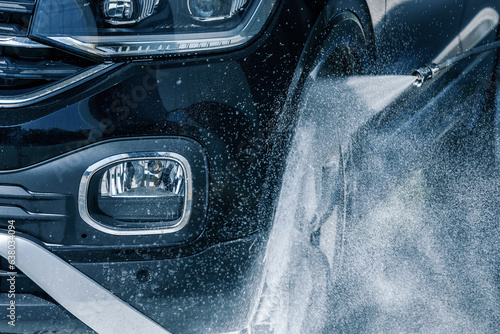 Konstfotografi Car washing with a high pressure water jet at an outdoor self-service  car wash station