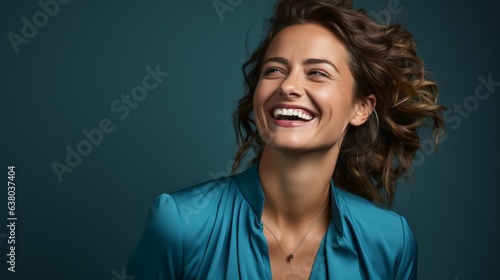 cheerful girl laughs looking at the camera on a blue background