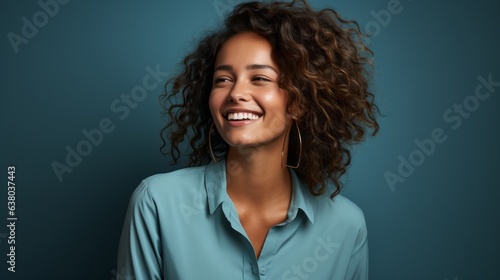 cheerful girl laughs looking at the camera on a blue background