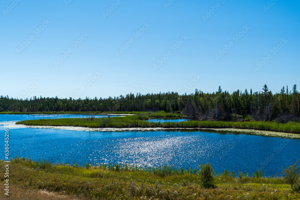 Beautiful lake sparkles in sunshine in Behchoko, Northwest territories, Canada