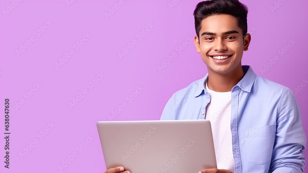 Happy Indian guy with laptop computer working or studying online on lilac background. Happy Indian guy with laptop computer working or studying online on lilac background.