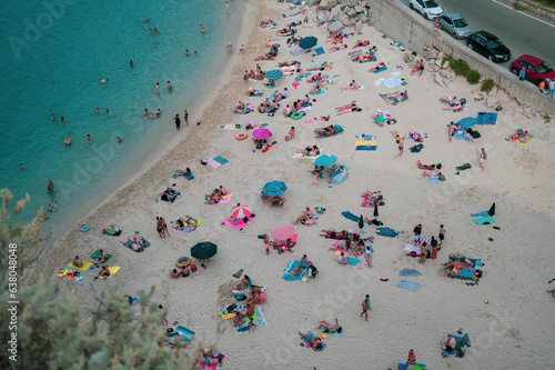 Italy, August 2023: beach, Caribbean sea and tourists enjoying their vacation day in Tropea in Calabria. An atmosphere of peace and serenity is perceived