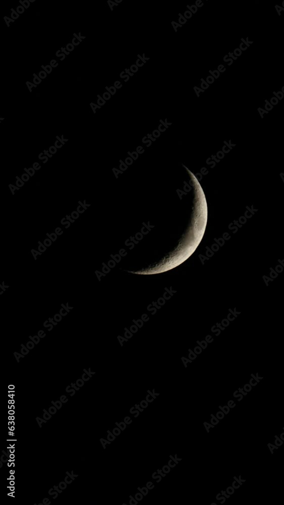 A time lapse close up of a new moon moving across the black dark night sky. Vertical video for social media. A time lapse close up of a new moon moving across the black dark night sky. Vertical video for social media.