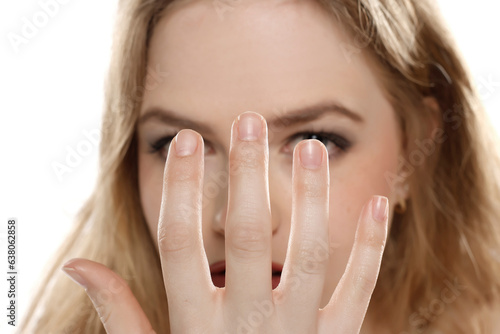 Closeup photo of woman shows her natural nails without nail polish.