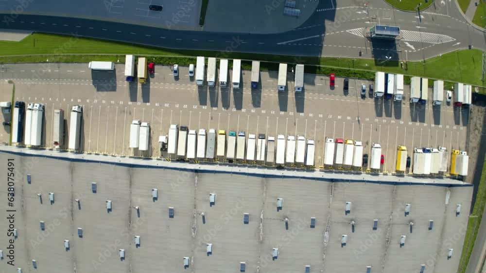 Aerial view of distribution center, drone photo of industrial logistics zone,new super modern logistics center full of modern technology and robotics,roof solar power plant for green energy production