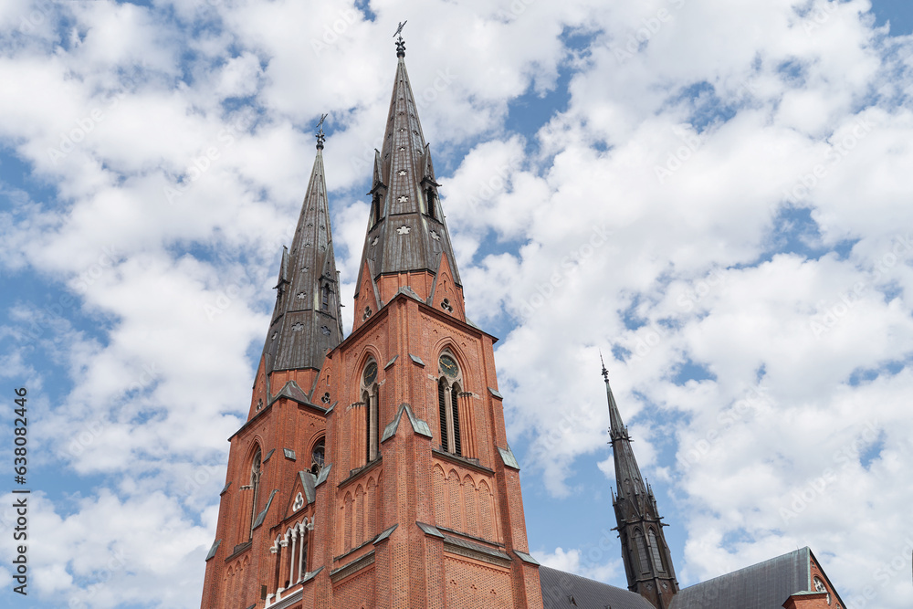 Uppsala Cathedral in Uppsala, Sweden on sky with clouds background
