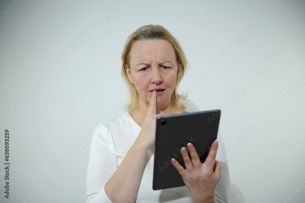 sad businesswoman is sitting at table, covering his face On desk is laptop, tablet computer, Stress. High quality photo sad businesswoman is sitting at table, covering his face On desk is laptop, tablet computer, Stress. High quality photo