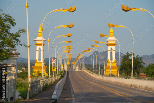 Thai Laos bridge with Mekong River with green mountain hill. Nature landscape background in Nong Khai, Thailand. photo