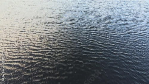 Flying low over a lake and tilting the camera up revealing the forest in Norway