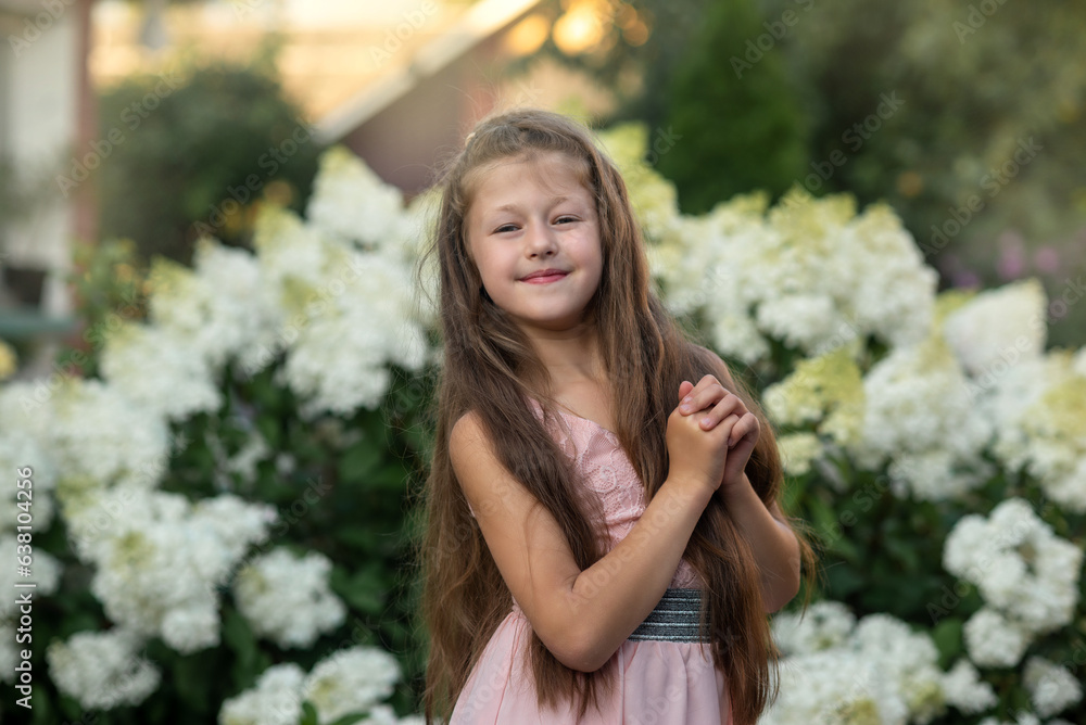 portrait of a girl in a park of hydrangeas