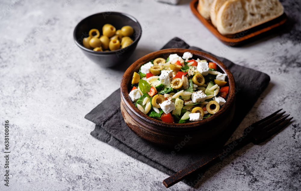 Spinach cucumber pepper orzo salad in a bowl Spinach cucumber pepper orzo salad in a bowl
