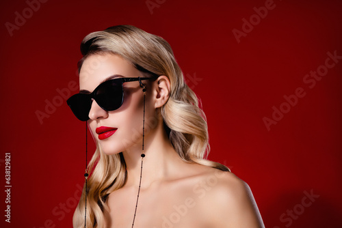 Photo of chic classy lady enjoy cosmetology spa center for rich people wear summer sunglass over red color background