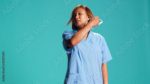 Valokuva Exhausted nurse happy to take off antibacterial facemask after finishing job shift