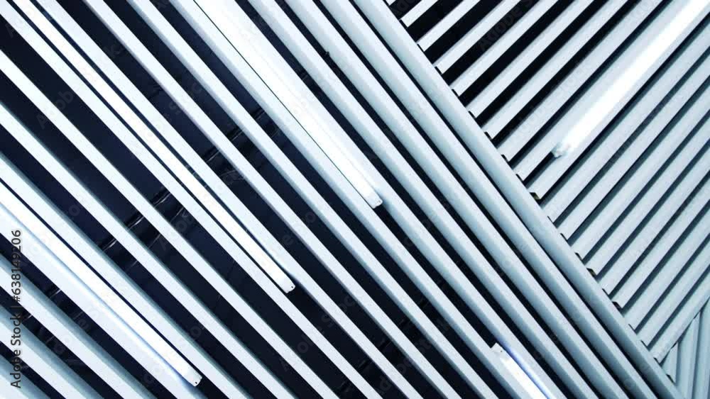 Long lamps of daylight on the ceiling. White planks parallel to the illumination equipment. Long lamps of daylight on the ceiling. White planks parallel to the illumination equipment.