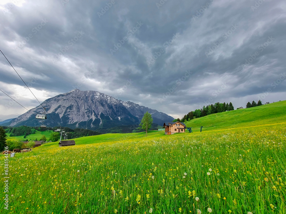Summer austrian landscape with Grimming mountain (2.351 m), an isolated peak in the Dachstein Mountains, view from small alpine village Tauplitz, Styria, Austria