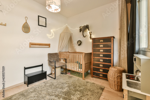 a baby's room with a cribt and other items on the wall in it, including a bed photo