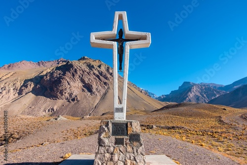 Isolated Large Religious Catholic Crucifix Cross, Outdoor Landmark at Entrance to Famous Mount Aconcagua Provincial Park, Andes Mountain Range Mendoza Argentina photo