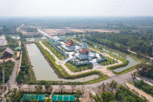 Aerial top view of Wat Pa Ban Tad, The Isan pagoda is a buddhist temple Udon Thani, an urban city town, Thailand. Thai architecture landscape background. Tourist attraction landmark.