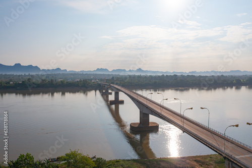 Aerial view of Thai Laos bridge with Mekong River with green mountain hill. Nature landscape background in Ubon Ratchathani  Thailand.