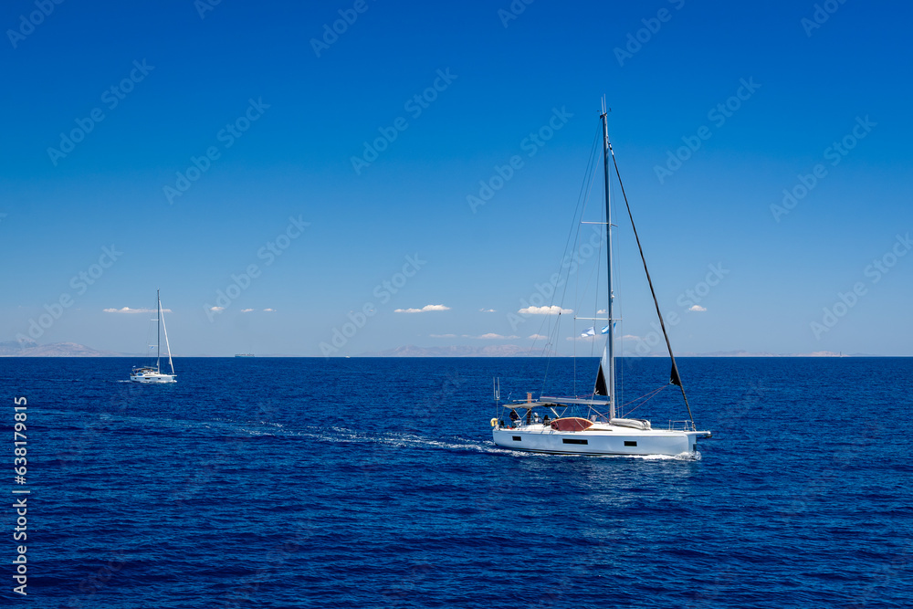Two beautiful white sailing boats in the blue waters of the Mediterranean Sea