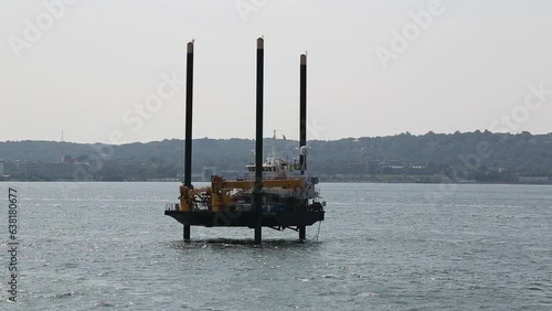 jack up barge in the new york city harbor (research, dredging, boat with legs, pylons, lift boat) photo