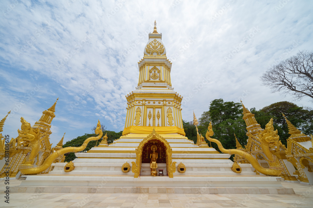 Obraz premium Wat Phrathat Phanom, Nakhon Phanom, Isan Temple. The pagoda is a buddhist temple in urban city town, Thailand. Thai architecture landscape background. Tourist attraction landmark.