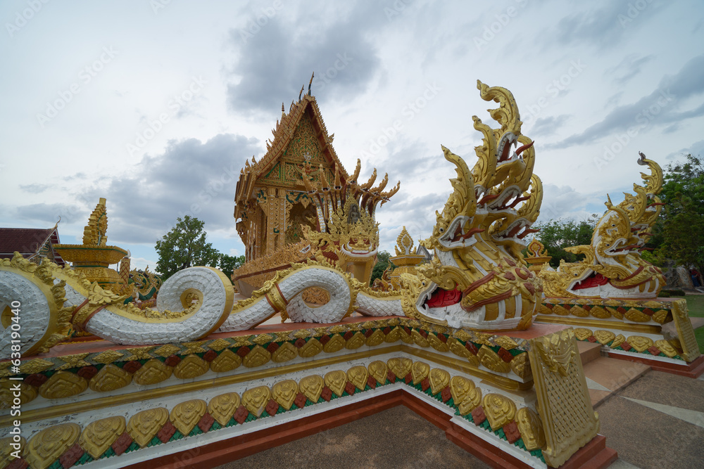 Fototapeta premium Wat Nong Hu Ling, Maha Sarakham, Isan Temple. The pagoda is a buddhist temple in urban city town, Thailand. Thai architecture landscape background. Tourist attraction landmark.