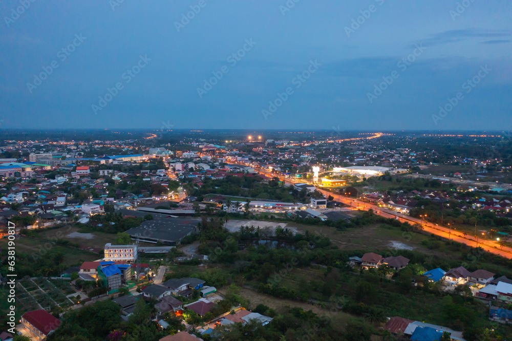 Aerial view of residential neighborhood roofs. Urban housing development from above. Top view. Real estate in Kalasin, Isan province city, Thailand. Property real estate at night.
