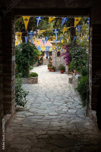 Holy Monastery of the Annunciation to the Virgin Mary, view through an old gate and cobbled street