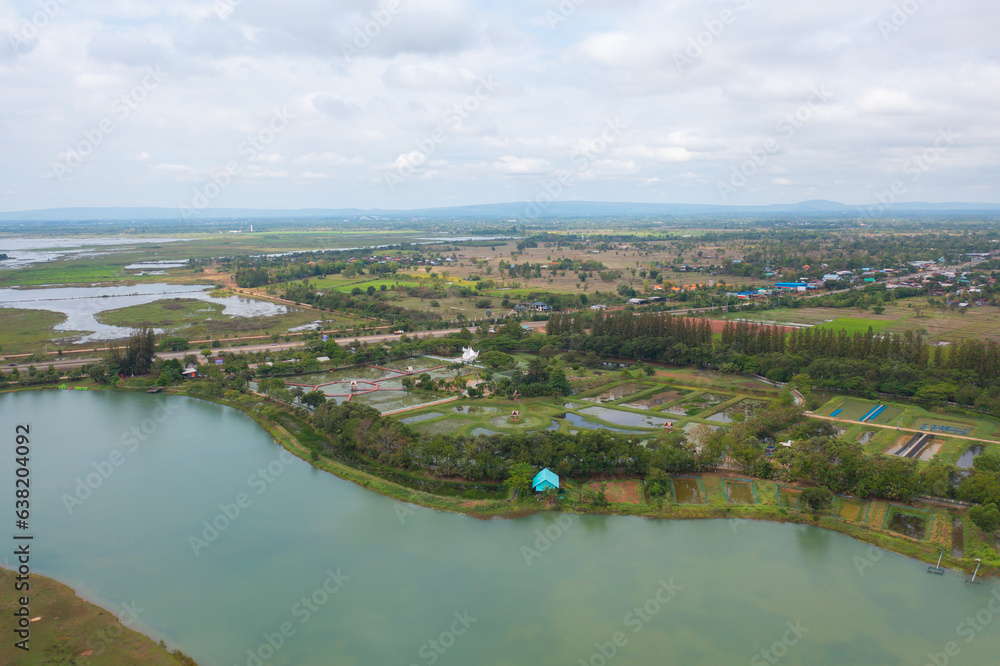 Aerial top view of a garden park with green forest trees, river, pond or lake. Nature landscape background, Thailand.