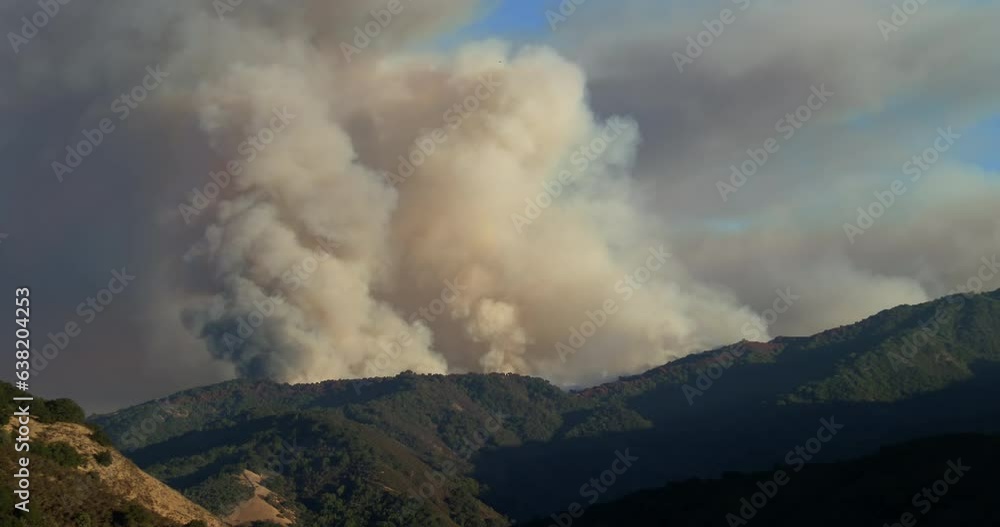 Loma Fire wildfire burning in Santa Cruz Mountains above San Jose with massive billowing smoke plume in late afternoon Loma Fire wildfire burning in Santa Cruz Mountains above San Jose with massive billowing smoke plume in late afternoon
